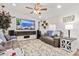 Bright living room with a large TV, fireplace, and comfortable seating at 43459 N Terrace View Ave, San Tan Valley, AZ 85140