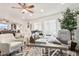 Bright home office with a large desk and comfortable seating at 43459 N Terrace View Ave, San Tan Valley, AZ 85140