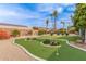 Landscaped backyard featuring a putting green, pool, and various desert plants with gravel at 502 E Le Marche Ave, Phoenix, AZ 85022