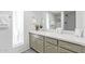 Stylish bathroom vanity featuring sage-colored cabinets, a modern faucet, and luxurious quartz countertops at 502 E Le Marche Ave, Phoenix, AZ 85022