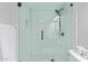 This is a shower with glass, white subway tile, black hardware, and patterned tile at 502 E Le Marche Ave, Phoenix, AZ 85022