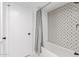 Bathroom featuring decorative tile, a bathtub with a shower, and a modern shower curtain at 502 E Le Marche Ave, Phoenix, AZ 85022