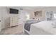 Bedroom featuring a decorative bed, a modern TV, and sliding glass doors to the exterior at 502 E Le Marche Ave, Phoenix, AZ 85022