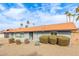 Charming one-story home featuring a desert-landscaped front yard with mature bushes and orange tile roof at 502 E Le Marche Ave, Phoenix, AZ 85022