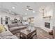 Spacious living room flowing into kitchen and backyard with large grey sofa at 502 E Le Marche Ave, Phoenix, AZ 85022