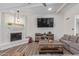 Inviting living room with painted brick fireplace, wooden floors, and comfortable grey sofa at 502 E Le Marche Ave, Phoenix, AZ 85022