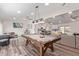 Open concept living room with a pool table, sleek wood floors, and modern furniture at 502 E Le Marche Ave, Phoenix, AZ 85022