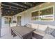 Cozy covered patio with outdoor seating, dining table, string lights, and backyard access at 502 E Le Marche Ave, Phoenix, AZ 85022