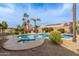 Beautiful desert backyard with lush green plants, a relaxing pool and raised hot tub at 502 E Le Marche Ave, Phoenix, AZ 85022