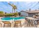 Backyard features a pristine private pool, desert landscaping, with outdoor dining and lounge chairs at 502 E Le Marche Ave, Phoenix, AZ 85022