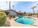 Backyard with refreshing pool, desert landscaping, table and lounge chairs at 502 E Le Marche Ave, Phoenix, AZ 85022