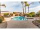 Relaxing desert backyard with lush landscaping, pool, raised hot tub, and an outdoor dining area at 502 E Le Marche Ave, Phoenix, AZ 85022