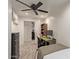 Small bedroom with twin bed, desk, and ceiling fan at 521 E Lehi Rd, Mesa, AZ 85203
