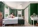 Green-walled bedroom with a queen bed and ample closet space at 521 E Lehi Rd, Mesa, AZ 85203