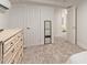 Small bedroom with twin bed and dresser, plus access to other rooms at 521 E Lehi Rd, Mesa, AZ 85203