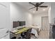 Small bedroom with twin bed, desk, and ceiling fan at 521 E Lehi Rd, Mesa, AZ 85203
