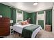 Serene bedroom with a queen bed, green walls, and natural light at 521 E Lehi Rd, Mesa, AZ 85203