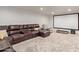 Basement home theater with sectional sofa and large projection screen at 521 E Lehi Rd, Mesa, AZ 85203