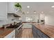Spacious kitchen featuring a large island, stainless steel appliances, and butcher block countertops at 521 E Lehi Rd, Mesa, AZ 85203