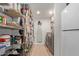Well-equipped laundry room with washer, dryer, and ample storage shelving at 521 E Lehi Rd, Mesa, AZ 85203