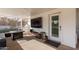 Relaxing covered patio with seating, fire pit, and TV at 521 E Lehi Rd, Mesa, AZ 85203