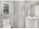 Cozy powder room featuring a toilet, sink, vanity, and window at 5374 W Chisum Trl, Phoenix, AZ 85083