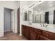 This bathroom includes a double sink vanity, an enclosed shower and a linen closet at 5374 W Chisum Trl, Phoenix, AZ 85083