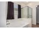 The bathroom showcases a soaking tub, a glass enclosed shower and a window with coverings at 5374 W Chisum Trl, Phoenix, AZ 85083