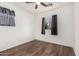 Bedroom featuring hardwood floors, a ceiling fan and a window letting in natural light at 5374 W Chisum Trl, Phoenix, AZ 85083