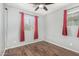 This bedroom features wood flooring, a ceiling fan, neutral walls and natural light from the window at 5374 W Chisum Trl, Phoenix, AZ 85083