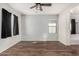 This bedroom has wood flooring, a ceiling fan, neutral walls and an ensuite bathroom at 5374 W Chisum Trl, Phoenix, AZ 85083