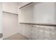 This walk-in closet provides ample storage with shelving and hanging rods for organization at 5374 W Chisum Trl, Phoenix, AZ 85083
