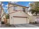 Two-story home with a two-car garage, neutral stucco, and reddish trim at 5374 W Chisum Trl, Phoenix, AZ 85083