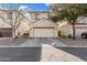 Two-story home with a two-car garage, neutral stucco, and reddish trim at 5374 W Chisum Trl, Phoenix, AZ 85083