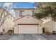 Two-story home with a two-car garage, neutral stucco, and reddish trim at 5374 W Chisum Trl, Phoenix, AZ 85083