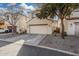 Two-story home with a two-car garage, neutral stucco, and reddish trim at 5374 W Chisum Trl, Phoenix, AZ 85083