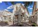 Two-story home with neutral stucco, reddish trim, an archway, and a balcony at 5374 W Chisum Trl, Phoenix, AZ 85083