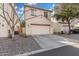 A two-car garage with a concrete driveway in front of a well-maintained home at 5374 W Chisum Trl, Phoenix, AZ 85083