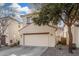 Exterior view of a two-story home with a two car garage, mature landscaping and a tidy yard at 5374 W Chisum Trl, Phoenix, AZ 85083