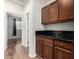 Hallway featuring wood floors and dark wood cabinets with black countertops at 5374 W Chisum Trl, Phoenix, AZ 85083