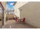 A covered patio features stone pavers and cozy seating at 5374 W Chisum Trl, Phoenix, AZ 85083