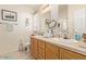 Bathroom boasts dual sinks, wood cabinets, and a large mirror at 8700 E University Dr # 1315, Mesa, AZ 85207