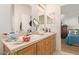 Double vanity bathroom with wood cabinets and access to bedroom at 8700 E University Dr # 1315, Mesa, AZ 85207