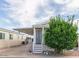 Mobile home exterior with covered porch and landscaping at 8700 E University Dr # 1315, Mesa, AZ 85207
