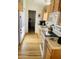 Bright kitchen featuring wood-look floors, wood cabinets and white appliances at 8700 E University Dr # 1315, Mesa, AZ 85207