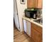 Well-lit kitchen with a stainless steel sink, dishwasher, and wood cabinets, optimizing space and functionality at 8700 E University Dr # 1315, Mesa, AZ 85207