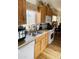 Functional kitchen with wood cabinetry, stainless steel sink, and white appliances at 8700 E University Dr # 1315, Mesa, AZ 85207