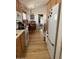 Bright kitchen features wooden cabinets and flooring leading to an adjacent dining area, creating an inviting space at 8700 E University Dr # 1315, Mesa, AZ 85207
