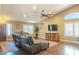Bright living room with vaulted ceilings, hardwood floors, and a comfortable leather sofa at 9441 E Juanita Ave, Mesa, AZ 85209