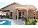 Relaxing backyard oasis with a sparkling pool, pergola, and patio furniture at 968 W Breckenridge Ave, Gilbert, AZ 85233